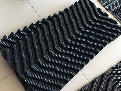 There are two pieces of cooling tower fills on the ground.